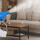 A person using a ULV fogger in a room